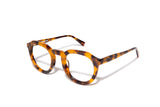 Image of Cheeterz Club eyewear. Photo of round eyeglasses with clear lenses and blue light blocking technology. The frames are medium width with glitter infused golden brown and black color and spotted print, suitable for square, oval, and oblong face shapes. These glasses can be used as reading glasses with blue light glasses.