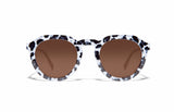 Image of Cheeterz Club eyewear. Photo of round sunglasses with brown tinted lenses. The frames are medium width with white and black color and cheetah print, suitable for square, oval, and oblong face shapes. 